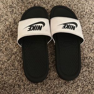 Nike slides!! Black base with white top and the Nike logo on it.
